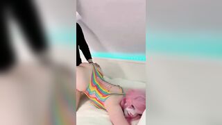 Belle Delphine Teases In Vibrant Rainbow Bodysuit